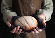 New Food Policing — Checkout Shock Ahead Person holding a freshly baked loaf of bread in a cloth