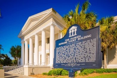 Florida Supreme Court Building with historic marker and white columns